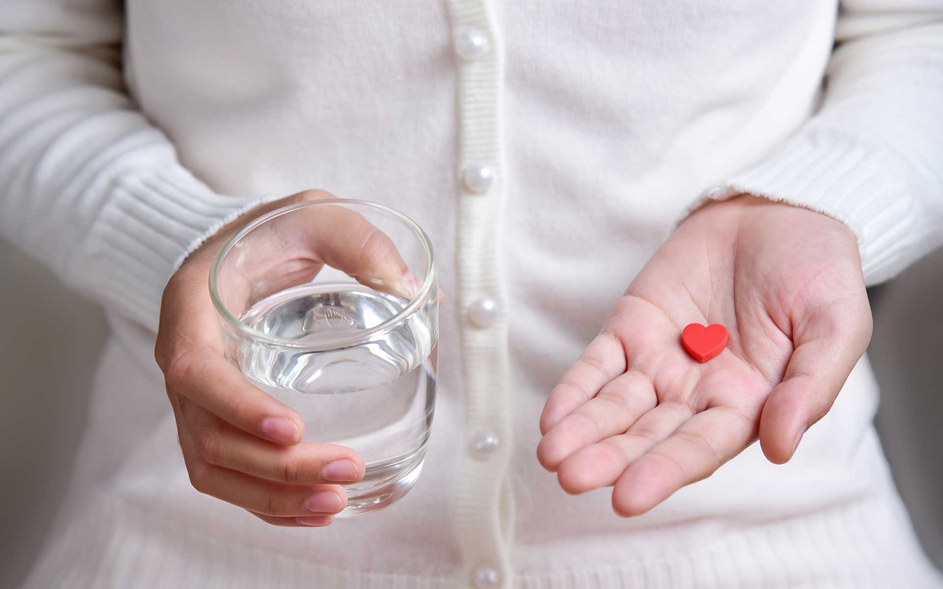 heart shaped pill and water