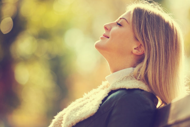 Woman inhaling contently, experiencing the benefits of well functioning Nucleotides