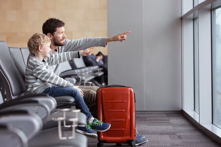 Father and Son happily waiting to board an airplane